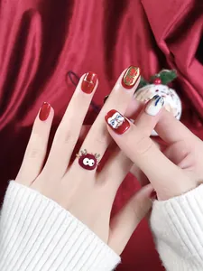 Detail of red festive press-on nails with Lion Dance motifs and a velvet ring
