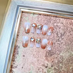 Handmade brown gradient press-on nails with silver butterfly charms and luxury rhinestones
