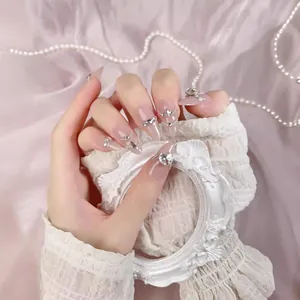 Handmade almond press-on nails with pink cat-eye effect, rhinestones, and pearls