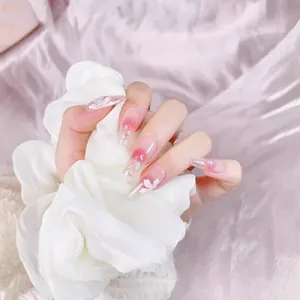 Pink gradient long trapezoid press-on nails with 3D white floral and glitter accents