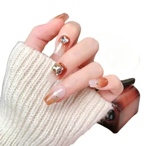 Handmade brown gradient press-on nails with shiny crystals and silver 3D butterflies
