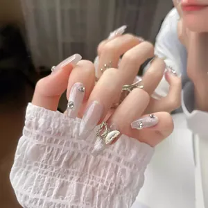 Sparkly silver cat-eye press-on nails with 3D metal butterflies and rhinestones