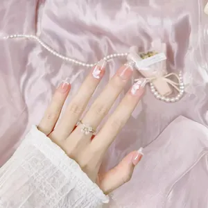 Pink gradient press-on nails with 3D white petals and pearls in French chic style