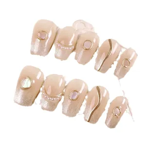 Handmade ballerina press-on nails with champagne gold glitter, pearls, and cat eye stones