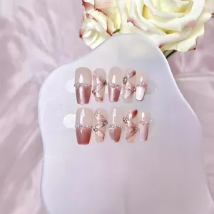 Handmade gradient pink press-on nails with bow ribbons, pearls, and crystals in 10pcs set