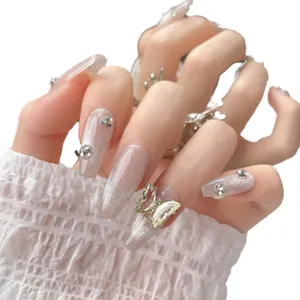 Handmade coffin press-on nails with nude cat-eye glitter and 3D butterfly crystals