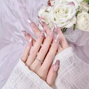 Pink French press-on nails with cat eye finish, silk ribbon bows and pearl accents