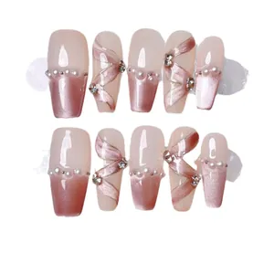 Pink cat eye press-on nails with white pearls and silver silk ribbon designs