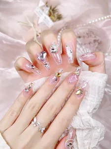 Detail of luxury press-on nails with 3D butterfly, purple zircon, and glitter gradient