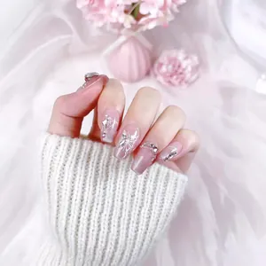 Handmade press-on nails with silver glitter gradient, white butterfly art, and 3D rhinestones