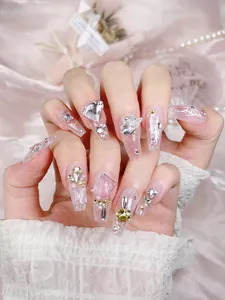 Detailed view of handmade press-on nails with 3D butterflies and heart crystal charms