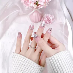 Pink gradient cat-eye press-on nails with luxury butterfly diamond charms and silver accents