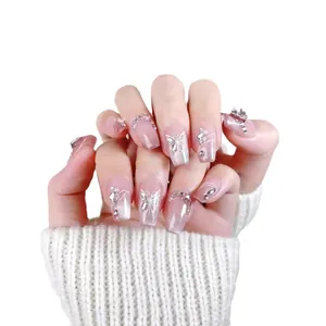 Cat eye pink gradient press-on nails with white butterfly and rhinestone details
