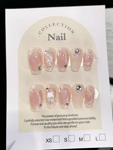 Macro view of handmade cat-eye press-on nails with shells, pearls, and star metal charms