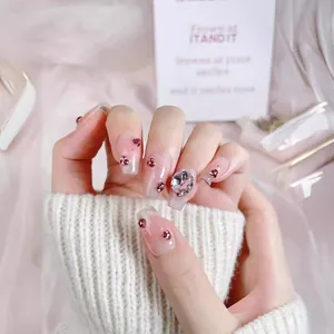 Handmade press-on nails with pink gradient, sparkling rhinestones and a large oval gem