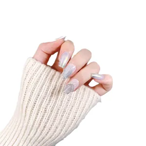 Faux ongles sirène irisés avec perles et détails de chaîne argentée sur fond blanc
