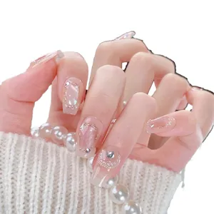 Handmade cat-eye press-on nails with shells, pearls and shimmering nude pink gradient
