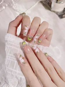 Detail of green cat-eye French tips and hand-painted lilies on long trapezoid nails