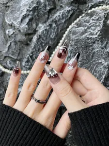 Detail of luxury French black gradient coffin nails with crystals and pearl accents
