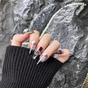Handmade stiletto press-on nails with black gradient, floral art, and 3D rhinestones
