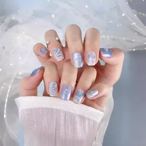 Handmade luxury press-on nails with blue cat-eye effect, pearls, and butterfly designs