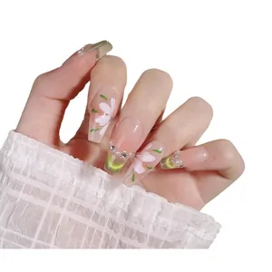 Handmade green floral cat eye press-on nails with white pearls in a long trapezoid shape