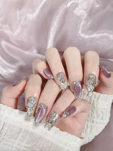 Detailed view of purple cat-eye press-on nails with silver 3D relief and pearls