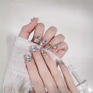 Sparkling long press-on nails with colorful heart rhinestones and glitter finish