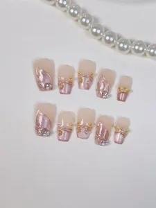 Detail of luxury press-on nails with cat eye finish, golden lines and pearls