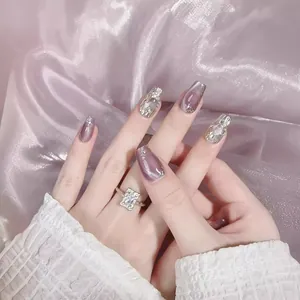 Purple cat eye press-on nails with silver 3D textures and subtle rhinestone accents