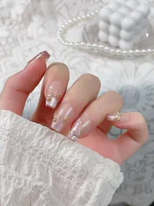 Detailed view of handmade press-on nails with mermaid tail design and pearls decoration