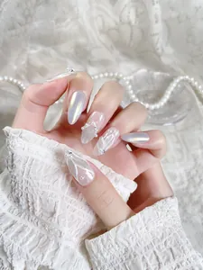 Detail of almond press-on nails with 3D pearls and white hand-painted feather designs