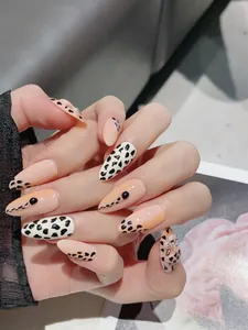 Detail view of long stiletto press-on nails with leopard print and 3D bead accents