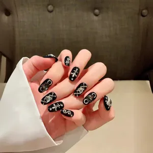 Gothic style handmade press-on nails with silver cross and snake charms in black