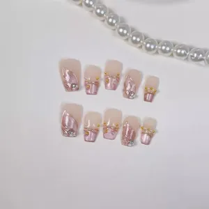 Handmade cat eye press-on nails in pink and champagne with gold relief and pearls