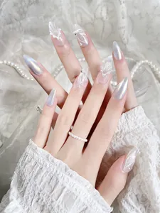 Detailed view of handmade press-on nails with 3D bows, aurora finish, and pearls