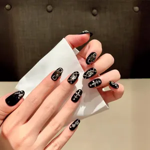 Handmade black press-on nails with gothic silver metallic charms and luxury rhinestones