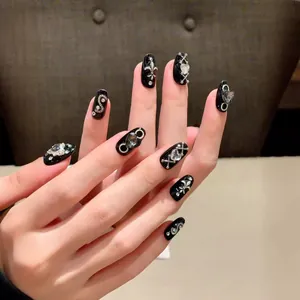 Gothic punk press-on nails with silver crosses, rhinestones and fleur-de-lis on black base