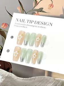 Detail of long ballerina press-on nails with cat-eye effect and white flower patterns