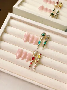 Exquisite handmade long press-on nails with luxury gems and gold floral relief details