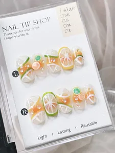 Detail of 3D fruit patterned press-on nails with lemon and orange relief designs