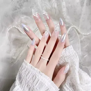 Elegant long almond press-on nails with white 3D floral carving and pearl accents
