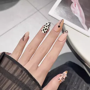 Handmade almond press-on nails featuring hand-painted leopard print and cow patterns