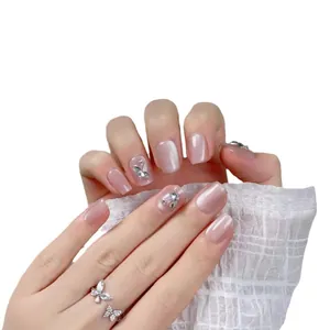Short handmade cat eye press-on nails in pearl pink with 3D silver butterfly rhinestones