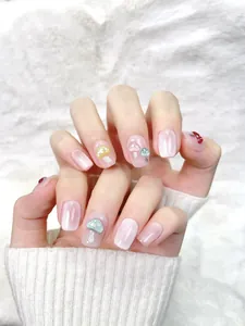 Macro detail of handmade cat eye press-on nails with 3D colorful mushroom ornaments