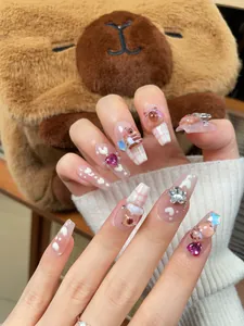 Detailed view of handmade long coffin nails featuring 3D brown bears and pink checkers