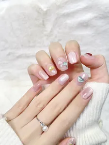 Macro detail of handmade cat eye press-on nails with 3D mushroom art and pearl ring