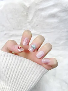 Detailed close-up of pink glitter press-on nails featuring 3D mushroom relief designs