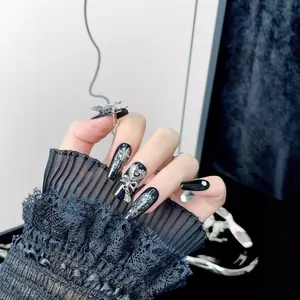 Y2K gothic style black press-on nails with silver glitter and butterfly charms