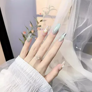 Long trapezoid press-on nails with mint green cat eye and white floral art